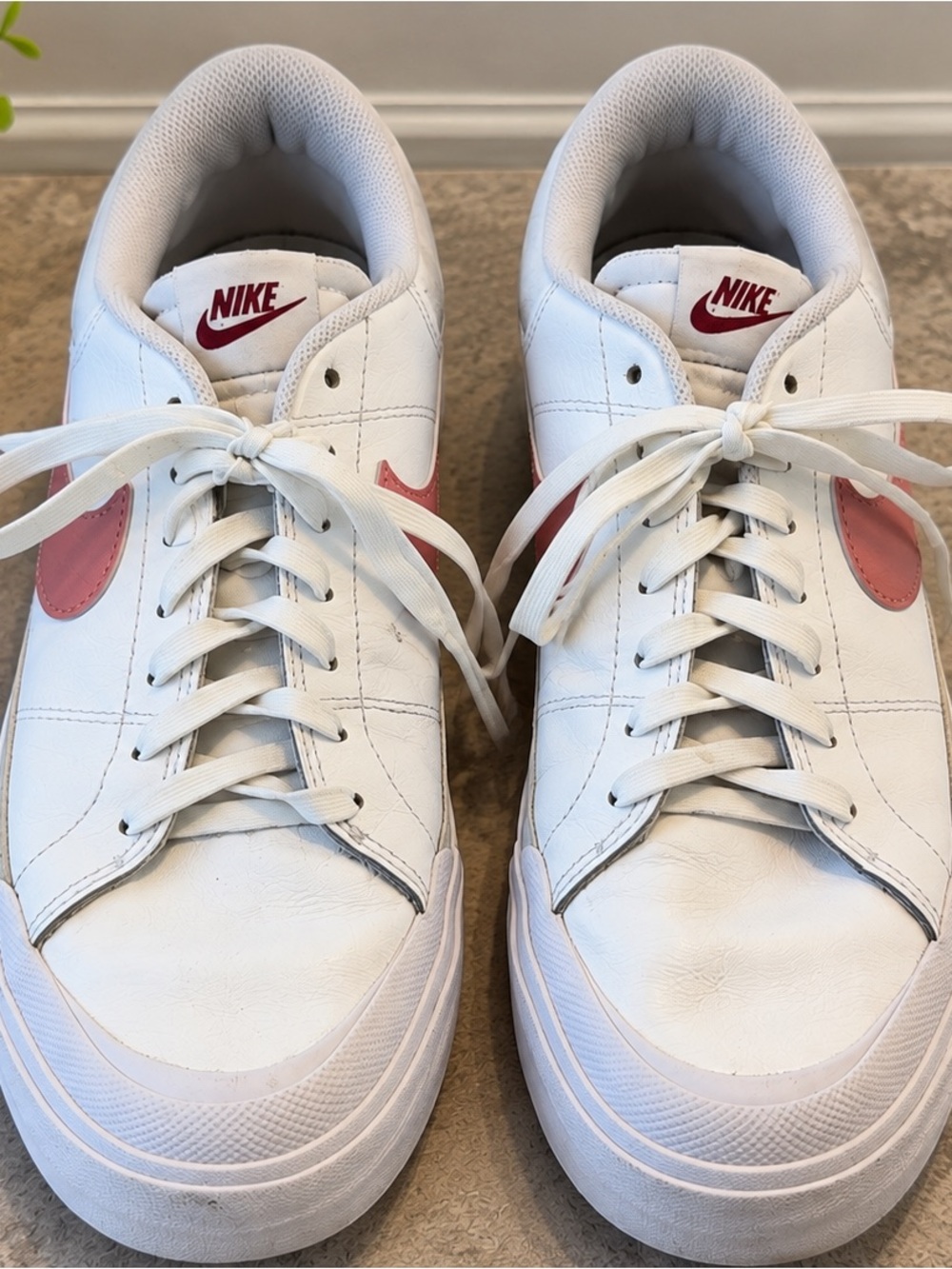 Nike Women’s White Leather Sneakers with Pink Swoosh Accents